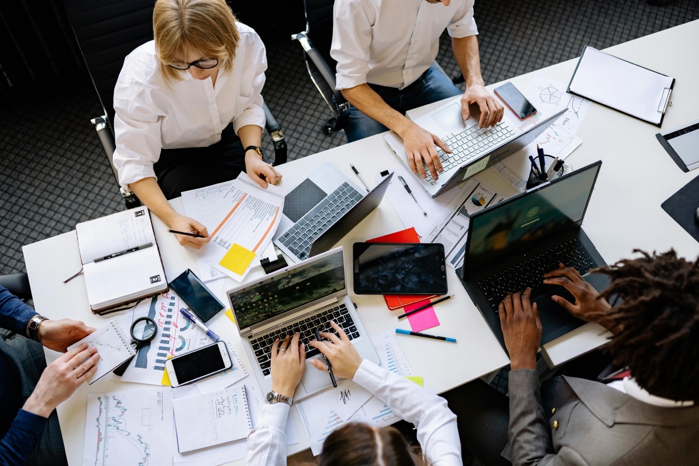 A group of people working at a desk